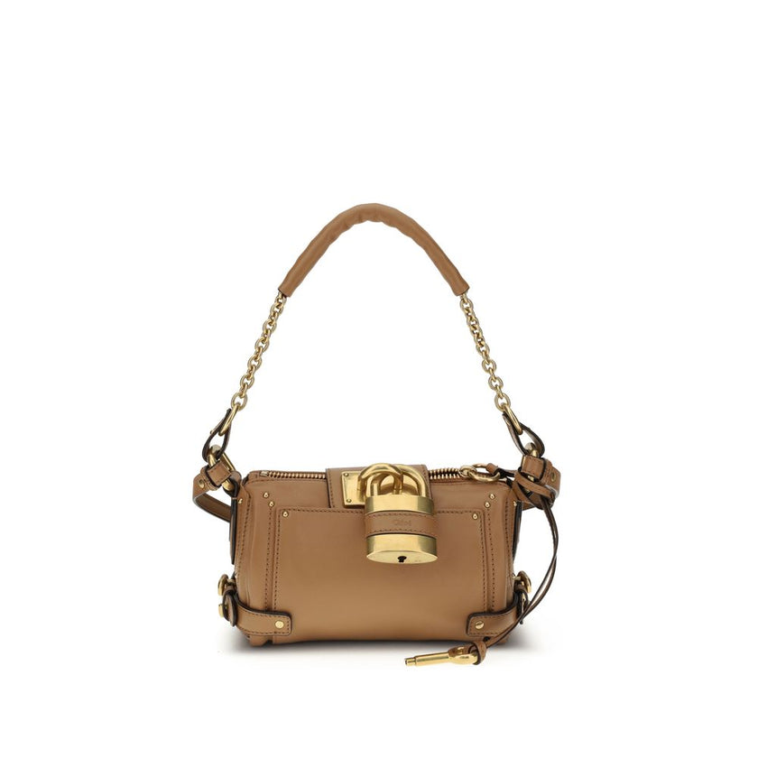 Brown Calf Leather Bos Taurus Shoulder BagPaddington Shoulder Bag by Chloé, crafted from soft garnet buffalo leather, stands out for its compact and flexible silhouette. Featuring a practical top zipper, it is embellished with iconic details such as an ov