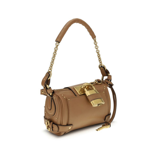 Brown Calf Leather Bos Taurus Shoulder BagPaddington Shoulder Bag by Chloé, crafted from soft garnet buffalo leather, stands out for its compact and flexible silhouette. Featuring a practical top zipper, it is embellished with iconic details such as an ov
