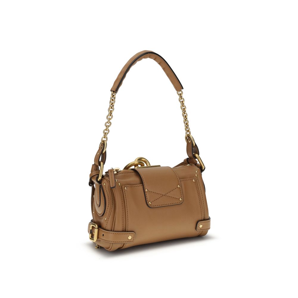 Brown Calf Leather Bos Taurus Shoulder BagPaddington Shoulder Bag by Chloé, crafted from soft garnet buffalo leather, stands out for its compact and flexible silhouette. Featuring a practical top zipper, it is embellished with iconic details such as an ov
