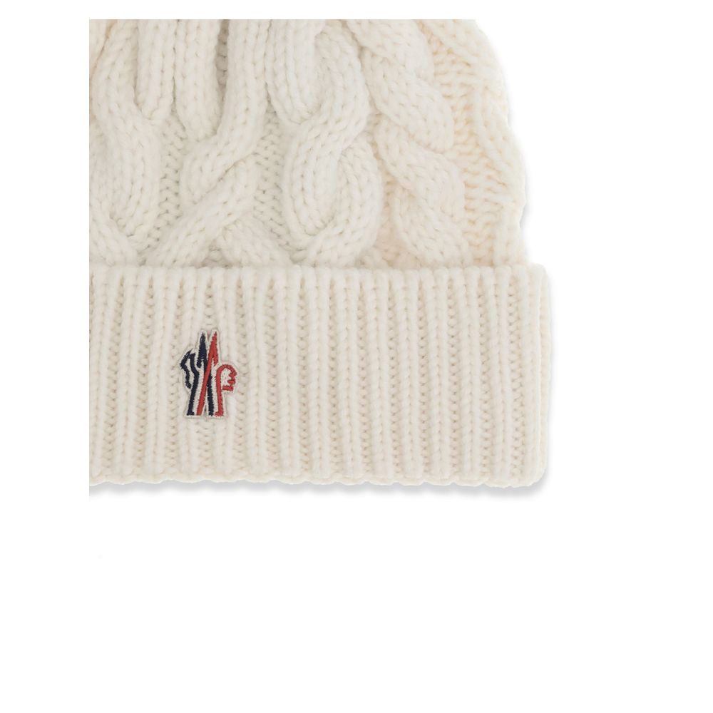White Fleece Wool BeanieBeanie Hat by Moncler Grenoble is made of extra fine wool yarn, perfect for providing warmth and comfort during the cold season. Characterized by a refined braided knit with fineness 3, it is completed by the iconic logo patch, a d