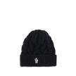 Black Fleece Wool BeanieBeanie Hat by Moncler Grenoble is made of extra fine wool yarn, perfect for providing warmth and comfort during the cold season. Characterized by a refined braided knit with fineness 3, it is completed by the iconic logo patch, a d