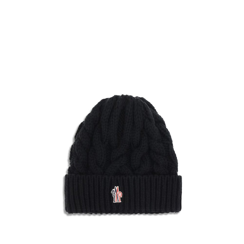 Black Fleece Wool BeanieBeanie Hat by Moncler Grenoble is made of extra fine wool yarn, perfect for providing warmth and comfort during the cold season. Characterized by a refined braided knit with fineness 3, it is completed by the iconic logo patch, a d