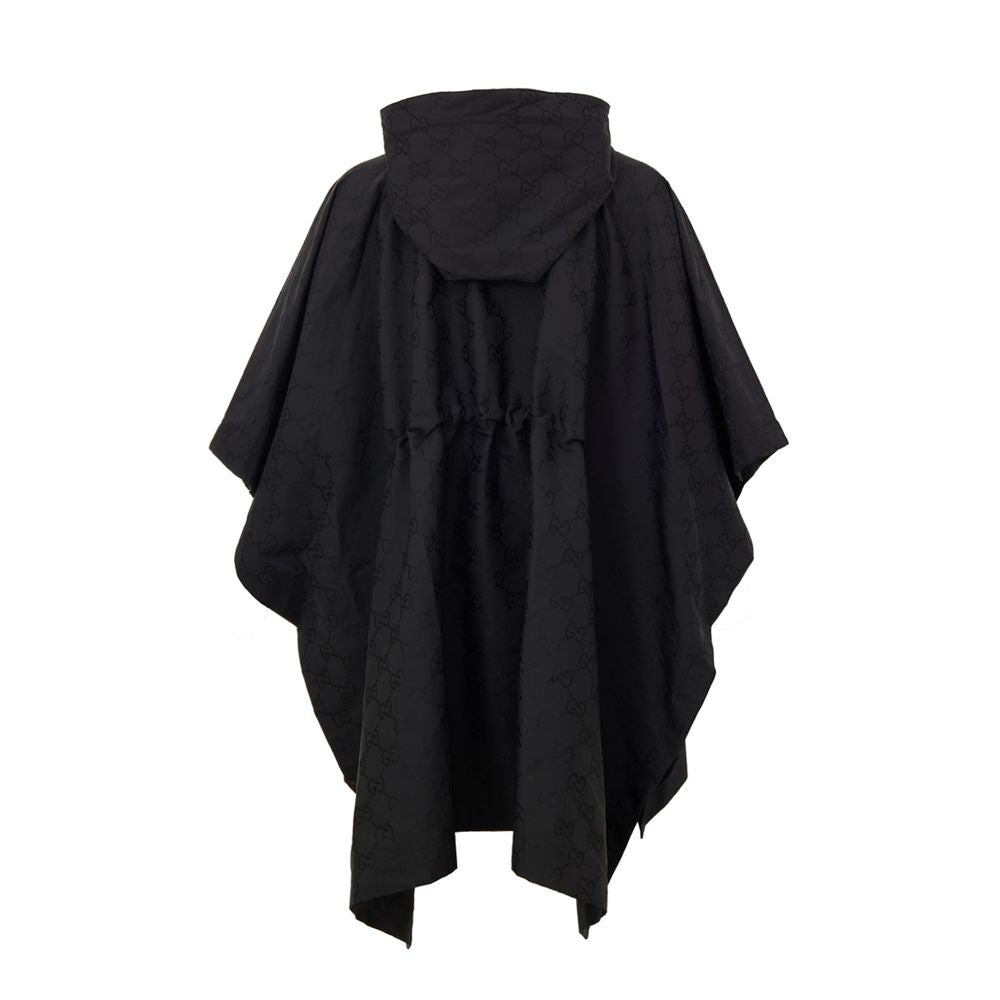 Black Polyester Trench CoatBlack Cape with Web Logo and Gucci GG Monogram Print. In black technical fabric, allover logo, maxi contrasting Gucci Web Logo on the front, adjustable hood and half zip on the front. Buttons on the sides to adjust the fit, adju