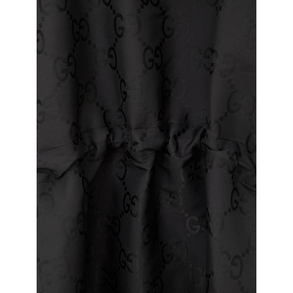 Black Polyester Trench CoatBlack Cape with Web Logo and Gucci GG Monogram Print. In black technical fabric, allover logo, maxi contrasting Gucci Web Logo on the front, adjustable hood and half zip on the front. Buttons on the sides to adjust the fit, adju