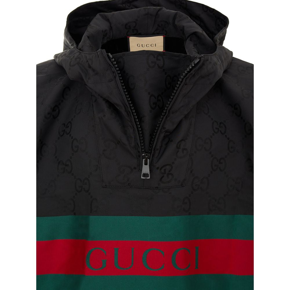 Black Polyester Trench CoatBlack Cape with Web Logo and Gucci GG Monogram Print. In black technical fabric, allover logo, maxi contrasting Gucci Web Logo on the front, adjustable hood and half zip on the front. Buttons on the sides to adjust the fit, adju