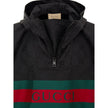 Black Polyester Trench CoatBlack Cape with Web Logo and Gucci GG Monogram Print. In black technical fabric, allover logo, maxi contrasting Gucci Web Logo on the front, adjustable hood and half zip on the front. Buttons on the sides to adjust the fit, adju