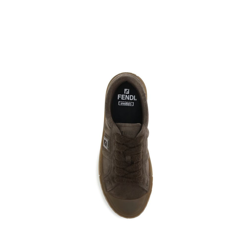 Brown Rubber Low Top SneakersDomino Sneakers by Fendi reinterpret urban style with refined details and high-quality materials. This low-top lace-up model is crafted in soft brown suede, with an elegant tone-on-tone metal FF side detail, enhanced by a ruth