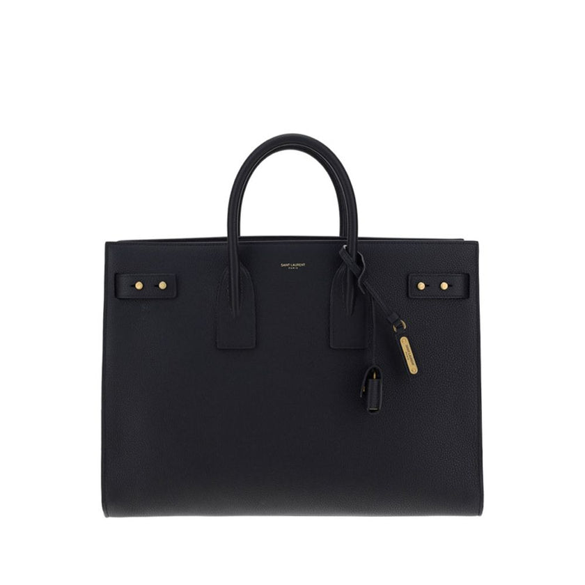 Black Calf Leather Bos Taurus HandbagThe Sac De Jour bag by Saint Laurent combines functionality and style with a soft structure, side gussets, and compression straps with tabs. It features round handles with a lock housed in a removable leather case and