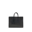 Black Calf Leather Bos Taurus HandbagThe Sac De Jour bag by Saint Laurent combines functionality and style with a soft structure, side gussets, and compression straps with tabs. It features round handles with a lock housed in a removable leather case and