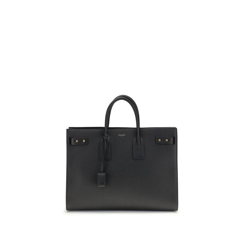 Black Calf Leather Bos Taurus HandbagThe Sac De Jour bag by Saint Laurent combines functionality and style with a soft structure, side gussets, and compression straps with tabs. It features round handles with a lock housed in a removable leather case and