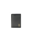 Black Calf Leather Bos Taurus WalletThe Tiny Cassandre credit Card Holder by Saint Laurent is a compact and sophisticated accessory designed for discreet elegance. Crafted with attention to detail, it is embellished with the YSL initials in pint-sized met