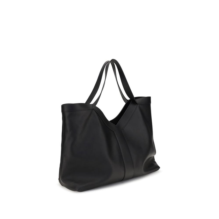 Black Calf Leather Bos Taurus Shoulder BagThe large Y Tote Bag by Saint Laurent is an elegant interpretation of the maison’s essential design. Crafted from finely grained leather and fully lined in tone-on-tone suede, it features the refined Y signature i