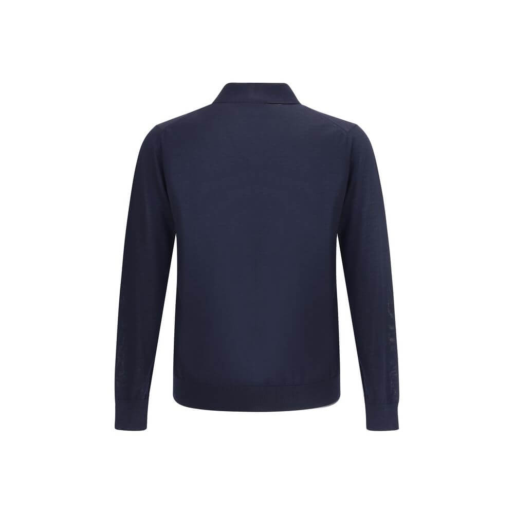 Wool Polo SweaterPrada’s Polo Sweater combines sporty elegance with iconic details. Featuring a classic collar and three-button front closure, it has ribbed cuffs and hem for a flawless finish. The contrasting embroidered logo on the front signs the garme