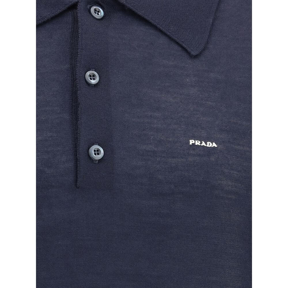 Wool Polo SweaterPrada’s Polo Sweater combines sporty elegance with iconic details. Featuring a classic collar and three-button front closure, it has ribbed cuffs and hem for a flawless finish. The contrasting embroidered logo on the front signs the garme