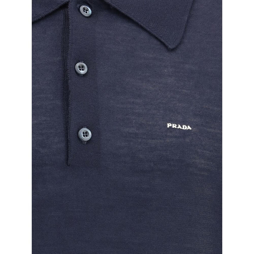 Wool Polo SweaterPrada’s Polo Sweater combines sporty elegance with iconic details. Featuring a classic collar and three-button front closure, it has ribbed cuffs and hem for a flawless finish. The contrasting embroidered logo on the front signs the garme