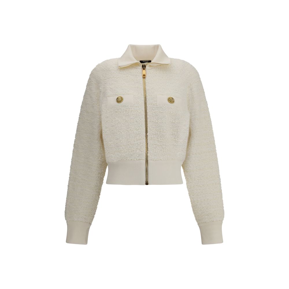 White Viscose BomberThe Tweed Bomber Jacket by Balmain reimagines a sporty classic with the Maison’s unmistakable elegance. Featuring a high collar and batwing long sleeves, it offers volume and modernity, while the decorative side pockets are detailed wi