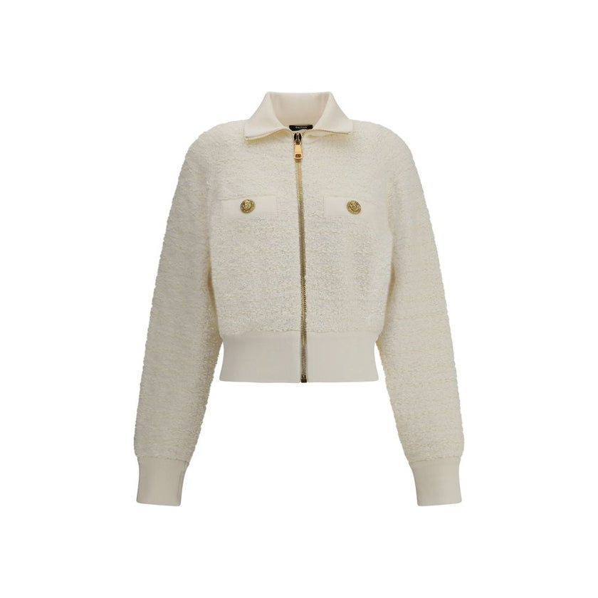White Viscose BomberThe Tweed Bomber Jacket by Balmain reimagines a sporty classic with the Maison’s unmistakable elegance. Featuring a high collar and batwing long sleeves, it offers volume and modernity, while the decorative side pockets are detailed wi