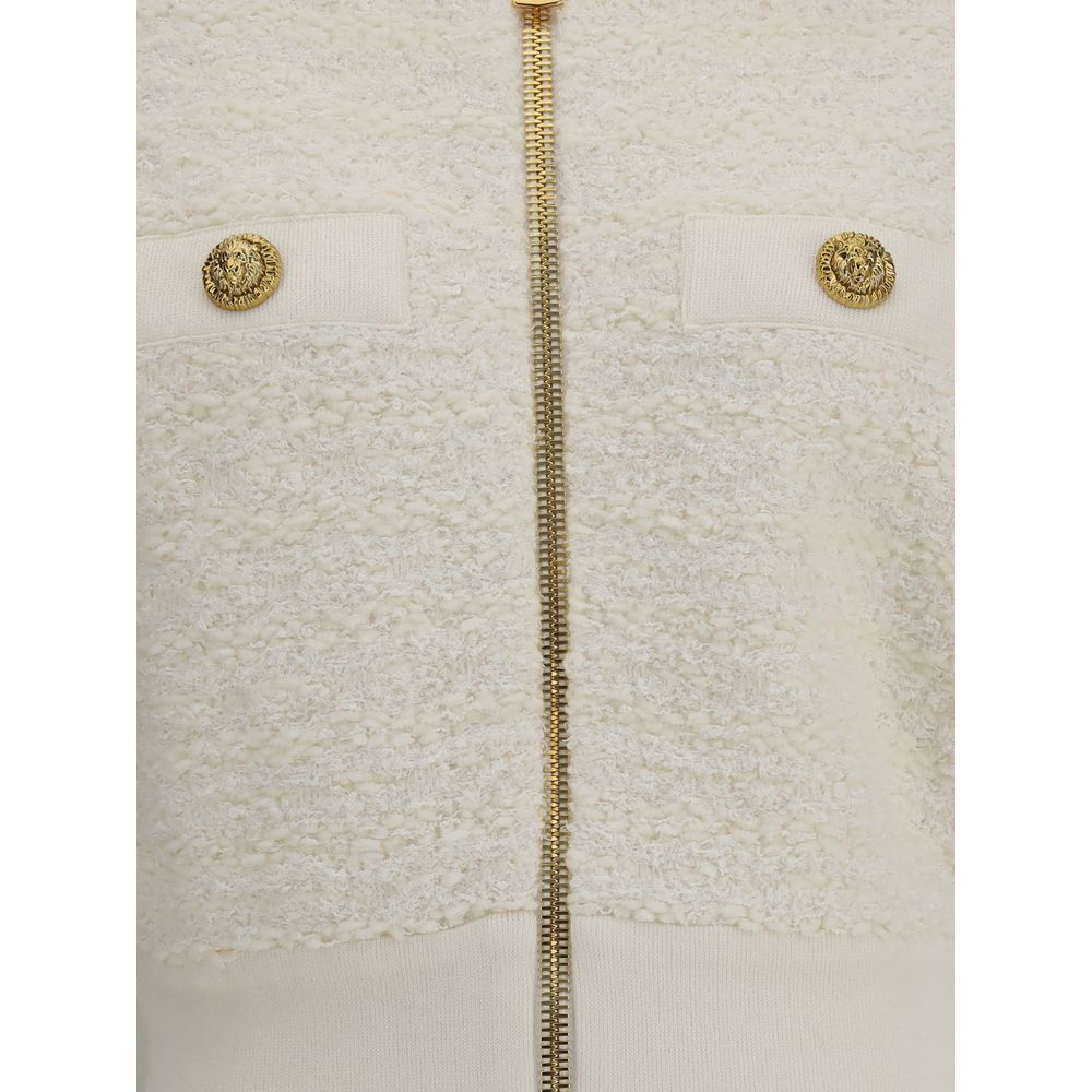 White Viscose BomberThe Tweed Bomber Jacket by Balmain reimagines a sporty classic with the Maison’s unmistakable elegance. Featuring a high collar and batwing long sleeves, it offers volume and modernity, while the decorative side pockets are detailed wi