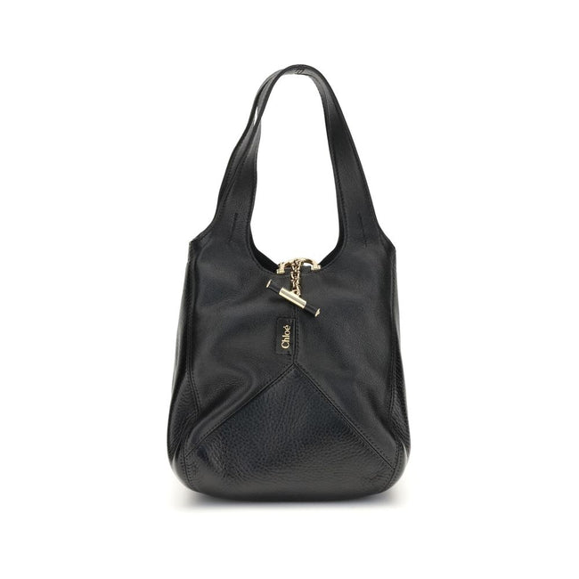 Black Buffalo Leather Shoulder BagThe small Balloon Shoulder Bag by Chloé combines elegance and craftsmanship. Crafted from grained buffalo leather with a shiny leather patchwork, it features a main compartment and a toggle closure. It can be carried by h