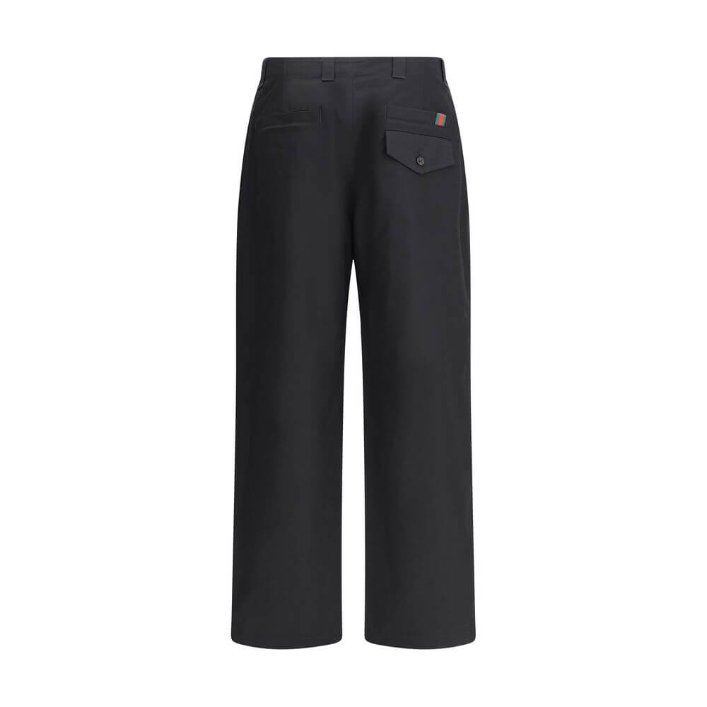 Black Cotton Casual PantsCotton Pants by Gucci with front zipper and button closure. They feature two side slash pockets, two welt pockets on the back, one with a flap, and belt loops at the waist. The monochrome pattern gives a clean and elegant look, pe