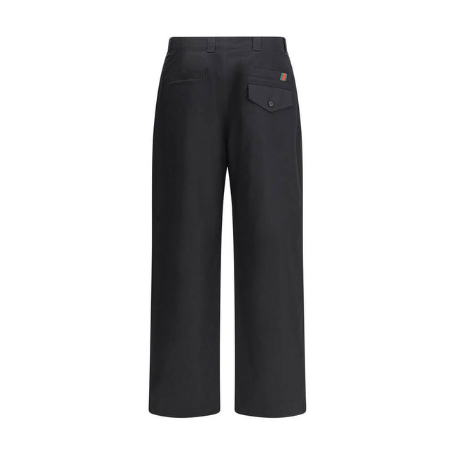 Black Cotton Casual PantsCotton Pants by Gucci with front zipper and button closure. They feature two side slash pockets, two welt pockets on the back, one with a flap, and belt loops at the waist. The monochrome pattern gives a clean and elegant look, pe