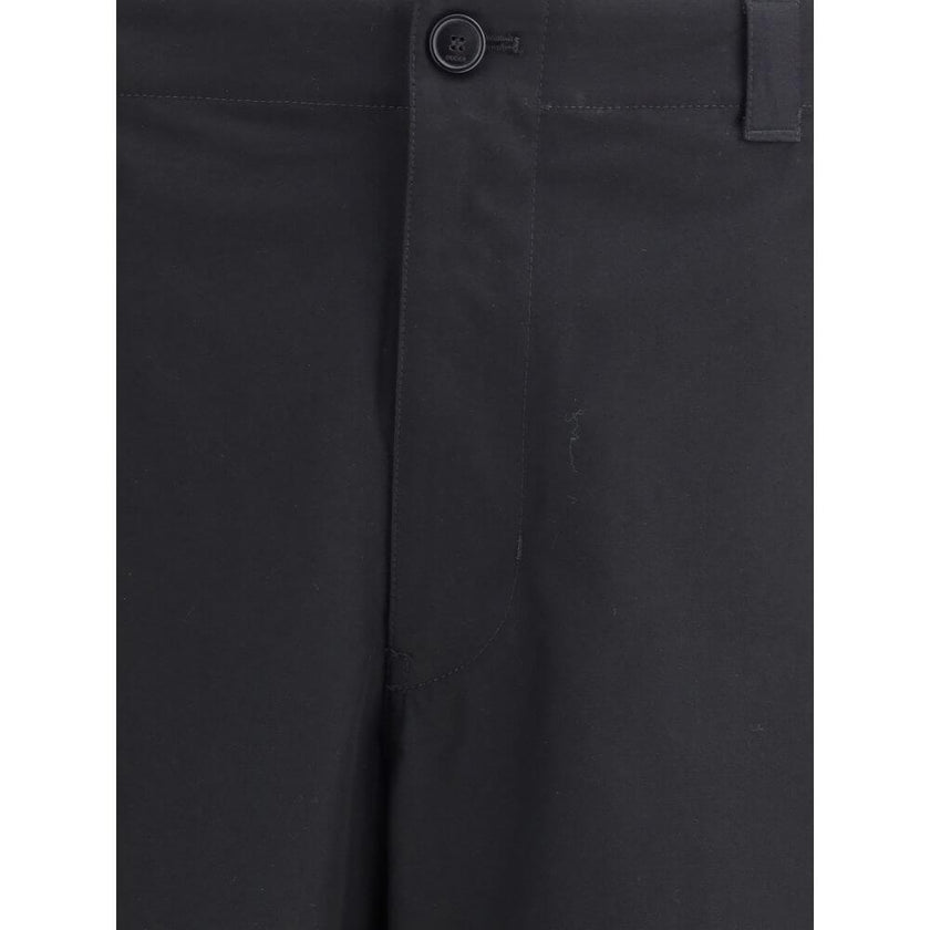 Black Cotton Casual PantsCotton Pants by Gucci with front zipper and button closure. They feature two side slash pockets, two welt pockets on the back, one with a flap, and belt loops at the waist. The monochrome pattern gives a clean and elegant look, pe