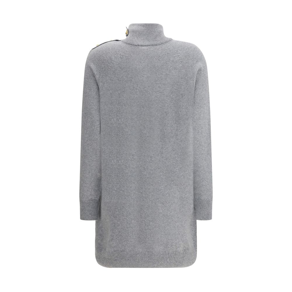 Gray Cashmere Casual DressThe Short Cashmere Sweater Dress by Balmain combines the softness of eco-friendly cashmere with a design of strong character. The high neck is detailed with a four-snap closure concealed under the placket, while decorative “Lion