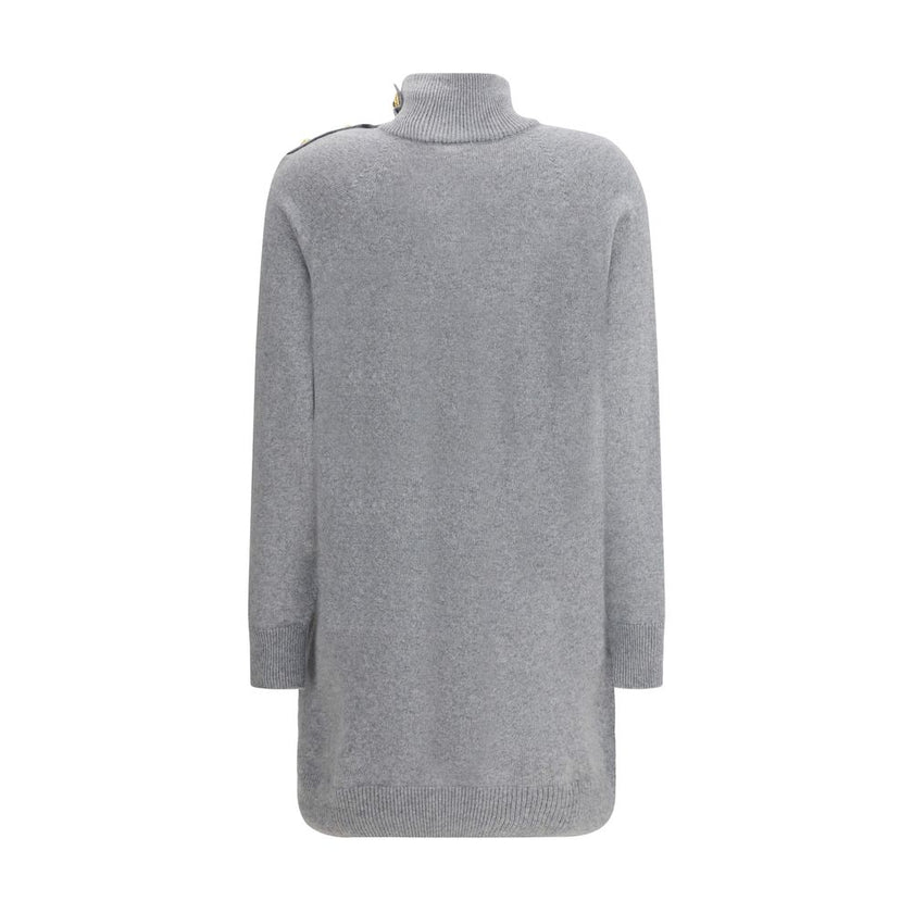 Gray Cashmere Casual DressThe Short Cashmere Sweater Dress by Balmain combines the softness of eco-friendly cashmere with a design of strong character. The high neck is detailed with a four-snap closure concealed under the placket, while decorative “Lion