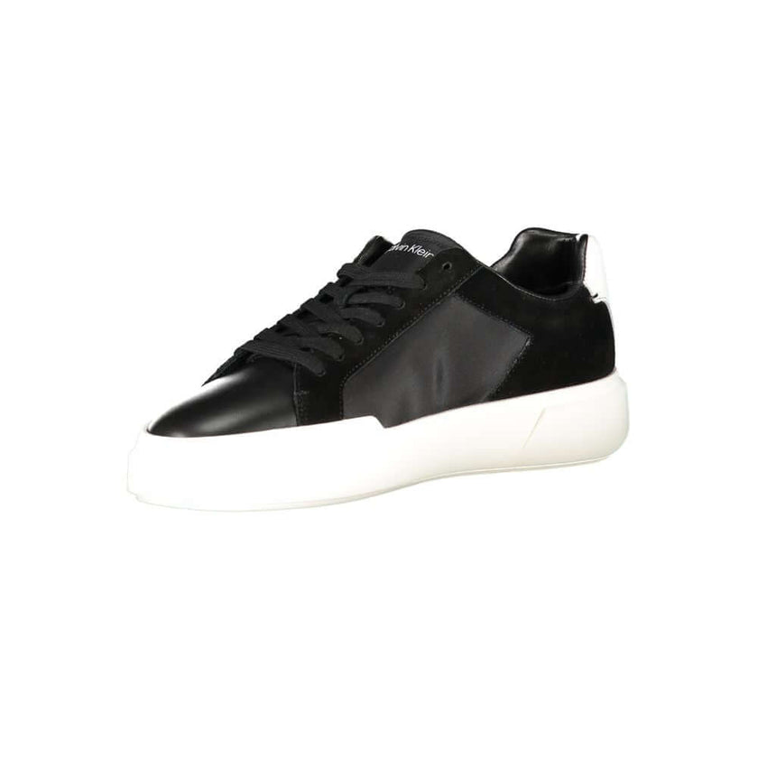Black Leather Men SneakerEmbark on a sartorial journey with the audacious spirit of Calvin Klein. These sneakers aren’t just footwear; they are a statement of contrast and sophistication. Designed to captivate with their bold black base and striking white