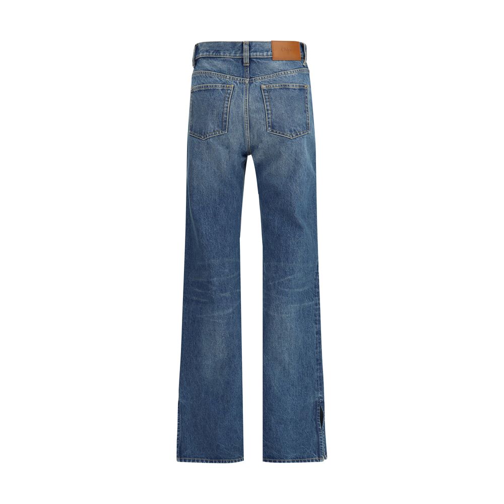Blue Cotton Straight-Leg JeansThe Organic Cotton Straight-Leg Denim Jeans by Chloé combine tradition and modernity with a refined indigo wash and a slit hem that adds movement to the silhouette. The front zip and Chloé-engraved button fastening enrich the