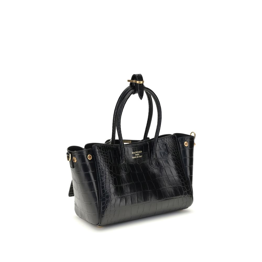 Bel Air mini Shoulder BagBalenciaga’s Bel Air mini Shoulder Bag is made of calfskin leather with crocodile processing, combining sophistication and iconic design. The carry-all model features two handles joined by a clip and an adjustable, removable shoul