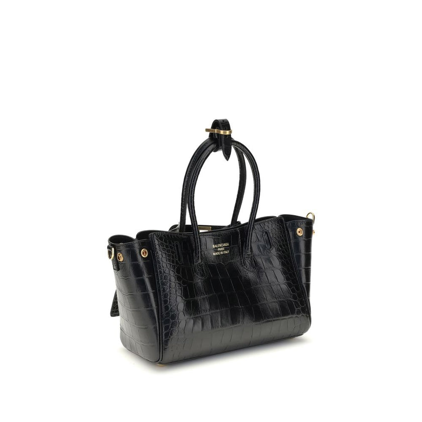 Bel Air mini Shoulder BagBalenciaga’s Bel Air mini Shoulder Bag is made of calfskin leather with crocodile processing, combining sophistication and iconic design. The carry-all model features two handles joined by a clip and an adjustable, removable shoul