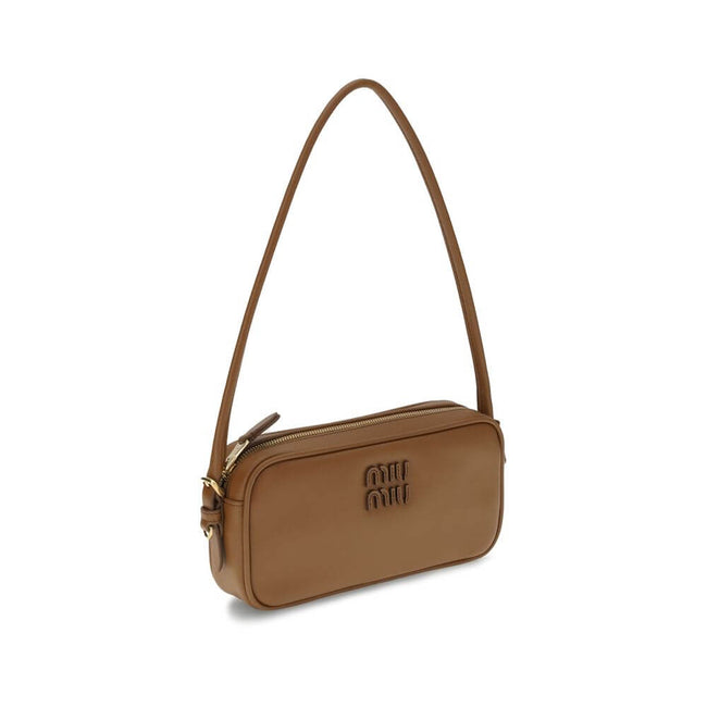 Brown Calf Leather Bos Taurus Shoulder BagShoulder Bag by Miu Miu is an elegant, minimalist accessory made of soft leather and embellished with tonal logo applique on the front, adding a discreet yet distinctive touch. Equipped with a round leather handle