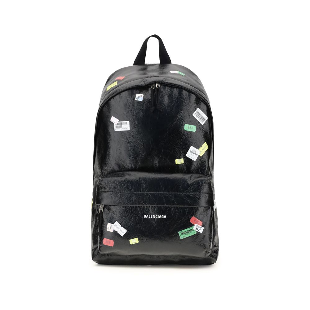 Black Lamb Ovis Aries Aries BackpackThe Explorer Backpack by Balenciaga is crafted from soft Arena lambskin, embellished with printed stickers for a distinctive, graphic touch. Featuring a top handle and adjustable shoulder straps, it features a two-way z
