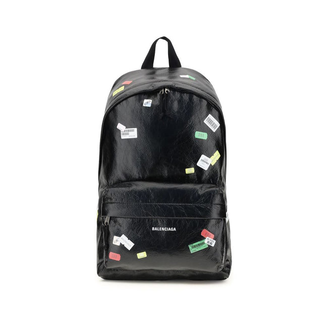 Black Lamb Ovis Aries Aries BackpackThe Explorer Backpack by Balenciaga is crafted from soft Arena lambskin, embellished with printed stickers for a distinctive, graphic touch. Featuring a top handle and adjustable shoulder straps, it features a two-way z