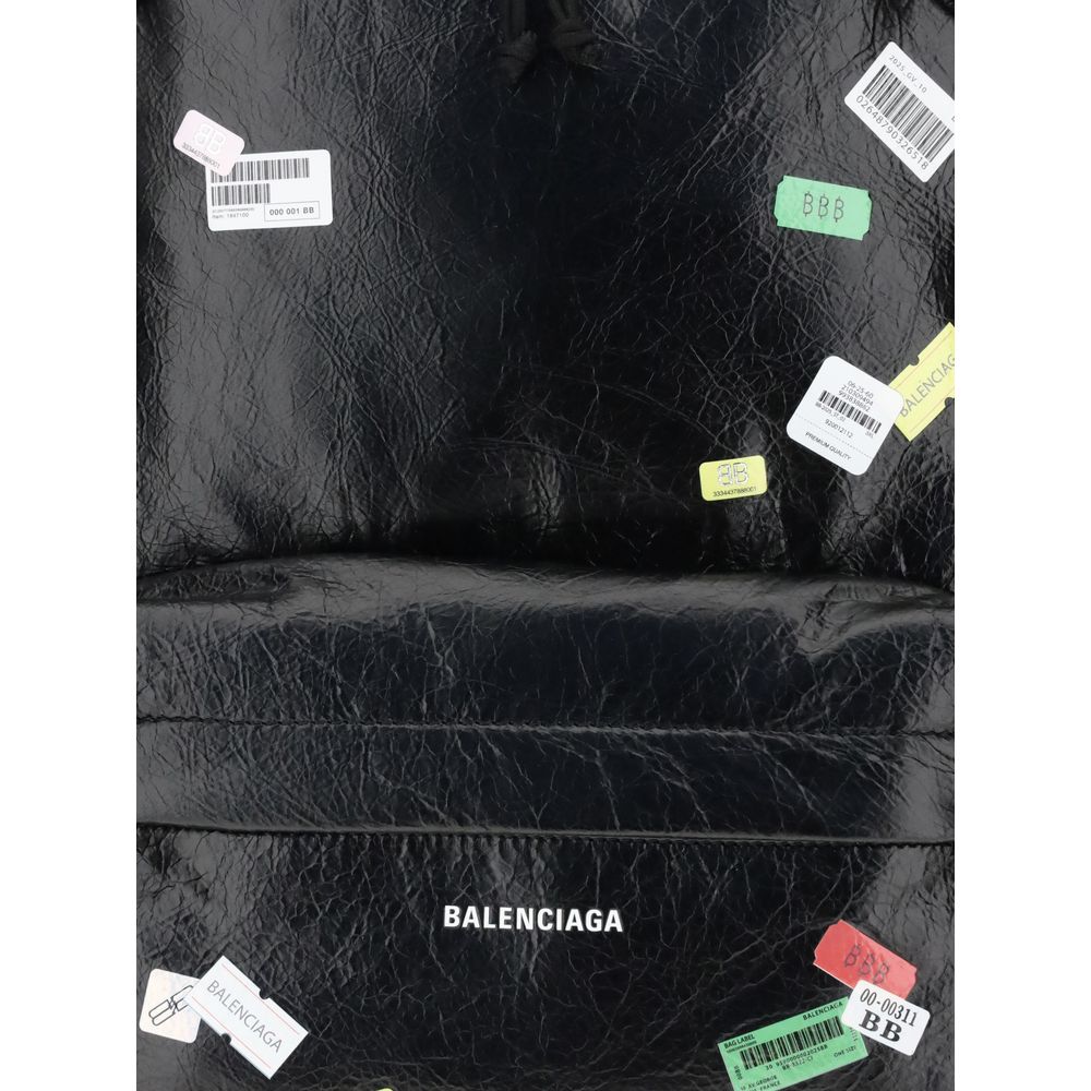 Black Lamb Ovis Aries Aries BackpackThe Explorer Backpack by Balenciaga is crafted from soft Arena lambskin, embellished with printed stickers for a distinctive, graphic touch. Featuring a top handle and adjustable shoulder straps, it features a two-way z