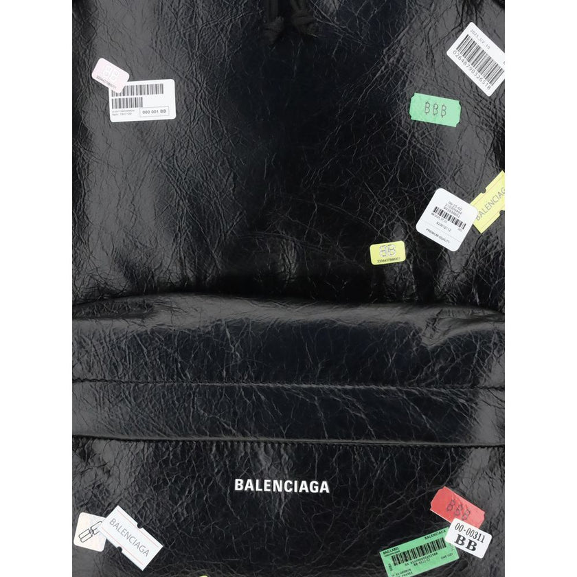 Black Lamb Ovis Aries Aries BackpackThe Explorer Backpack by Balenciaga is crafted from soft Arena lambskin, embellished with printed stickers for a distinctive, graphic touch. Featuring a top handle and adjustable shoulder straps, it features a two-way z