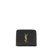Black Calf Leather Bos Taurus WalletCassandre matelassé Wallet by Saint Laurent is a compact and sophisticated model, featuring the iconic intertwined YSL initials in gold-tone metal at the center and quilted stitching that enhances its elegance. The inte