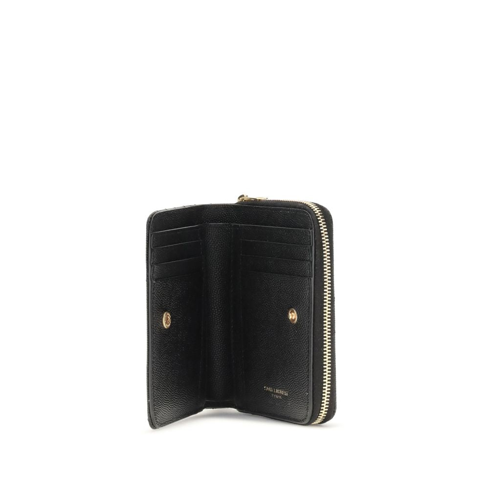 Black Calf Leather Bos Taurus WalletCassandre matelassé Wallet by Saint Laurent is a compact and sophisticated model, featuring the iconic intertwined YSL initials in gold-tone metal at the center and quilted stitching that enhances its elegance. The inte