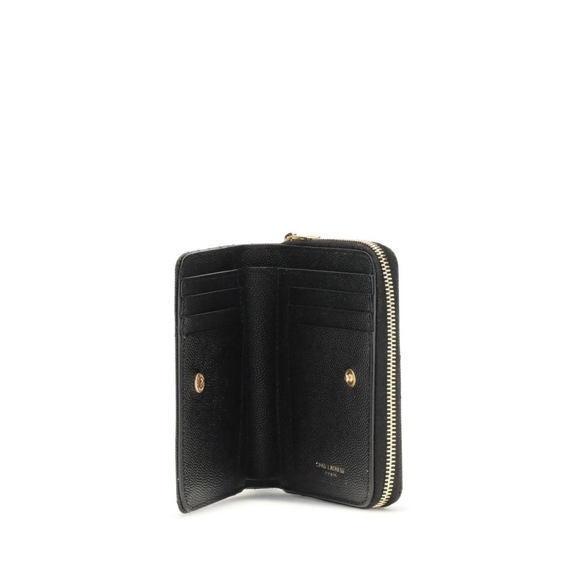 Black Calf Leather Bos Taurus WalletCassandre matelassé Wallet by Saint Laurent is a compact and sophisticated model, featuring the iconic intertwined YSL initials in gold-tone metal at the center and quilted stitching that enhances its elegance. The inte