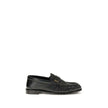 Black Lamb Ovis Aries Aries Slip-On LoafersLe Loafer Loafers by Saint Laurent combine classic elegance and iconic details. Crafted from supple leather, they feature a hand-stitched moc toe and the signature CASSANDRE embellishment in gold-tone metal. The