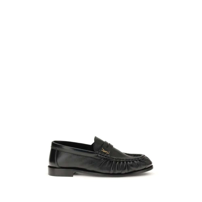 Black Lamb Ovis Aries Aries Slip-On LoafersLe Loafer Loafers by Saint Laurent combine classic elegance and iconic details. Crafted from supple leather, they feature a hand-stitched moc toe and the signature CASSANDRE embellishment in gold-tone metal. The