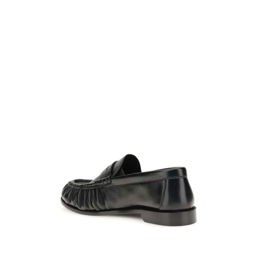 Black Lamb Ovis Aries Aries Slip-On LoafersLe Loafer Loafers by Saint Laurent combine classic elegance and iconic details. Crafted from supple leather, they feature a hand-stitched moc toe and the signature CASSANDRE embellishment in gold-tone metal. The