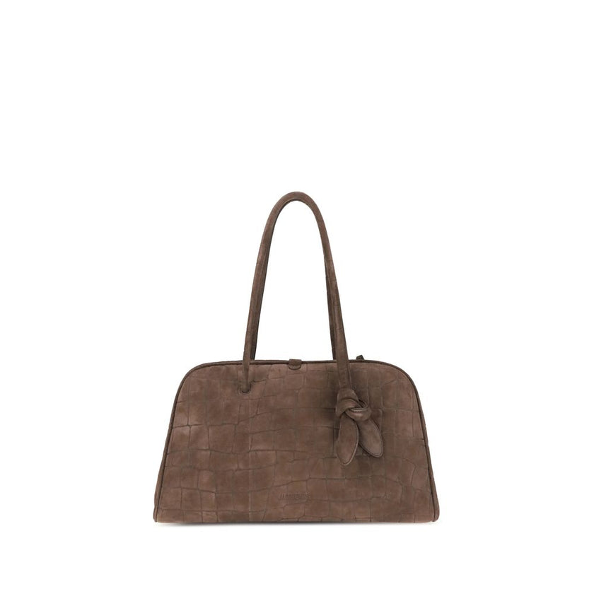 Il Turismo Shoulder BagThe Il Turismo Shoulder Bag by Jacquemus reinterprets the classic bowling bag with a contemporary twist. Crafted from crocodile-embossed suede, it features a two-way zip closure and matching tubular leather handles with a knotted de