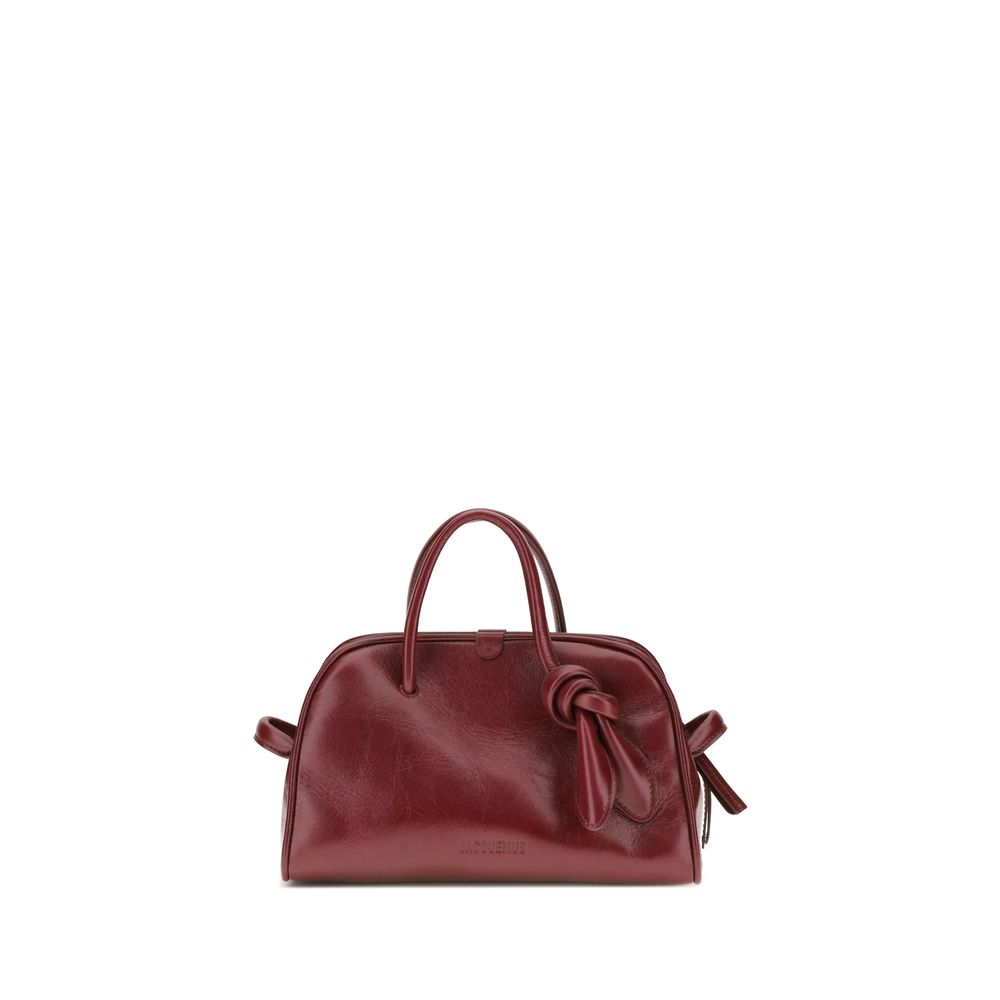 Bordeaux Calf Leather Bos Taurus HandbagThe Turismo Handbag by Jacquemus is crafted from polished leather with a sophisticated finish. The compact design is completed by a two-way zip closure, an internal zip pocket for easy organization, and an elegant b