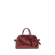 Bordeaux Calf Leather Bos Taurus HandbagThe Turismo Handbag by Jacquemus is crafted from polished leather with a sophisticated finish. The compact design is completed by a two-way zip closure, an internal zip pocket for easy organization, and an elegant b