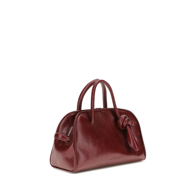 Bordeaux Calf Leather Bos Taurus HandbagThe Turismo Handbag by Jacquemus is crafted from polished leather with a sophisticated finish. The compact design is completed by a two-way zip closure, an internal zip pocket for easy organization, and an elegant b