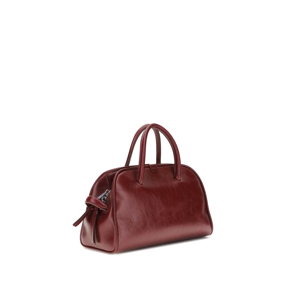 Bordeaux Calf Leather Bos Taurus HandbagThe Turismo Handbag by Jacquemus is crafted from polished leather with a sophisticated finish. The compact design is completed by a two-way zip closure, an internal zip pocket for easy organization, and an elegant b