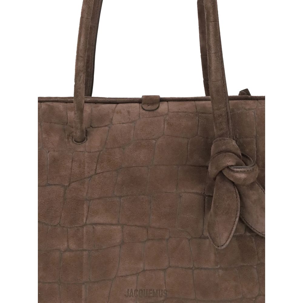 Il Turismo Shoulder BagThe Il Turismo Shoulder Bag by Jacquemus reinterprets the classic bowling bag with a contemporary twist. Crafted from crocodile-embossed suede, it features a two-way zip closure and matching tubular leather handles with a knotted de