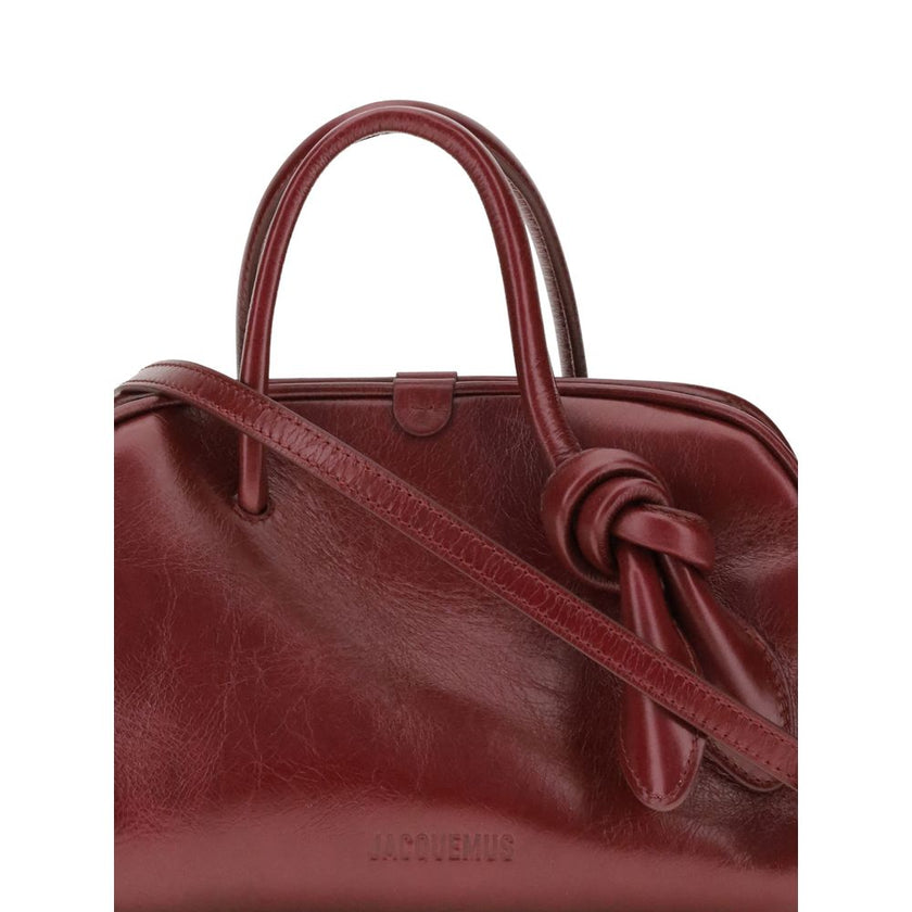 Bordeaux Calf Leather Bos Taurus HandbagThe Turismo Handbag by Jacquemus is crafted from polished leather with a sophisticated finish. The compact design is completed by a two-way zip closure, an internal zip pocket for easy organization, and an elegant b